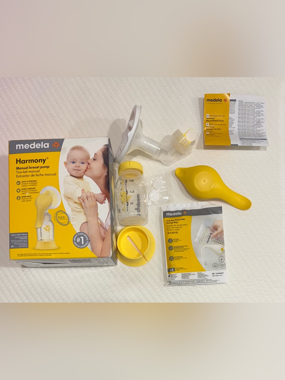 Medela Manual Breast Pump with Yellow Accents and Clear Bottle